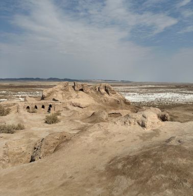 Near Toprak Kala, a ruin and salt on the desert sand.