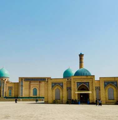 Across the plaza, a modern mosque and the small building on the right is the Muyi Mubarak Madrassah where the Osman Quran is kept.