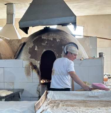Fresh bread coming out.
