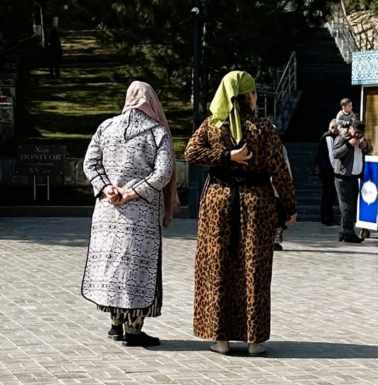 Women waiting at Daniel's tomb and a little boy gets a treat.
